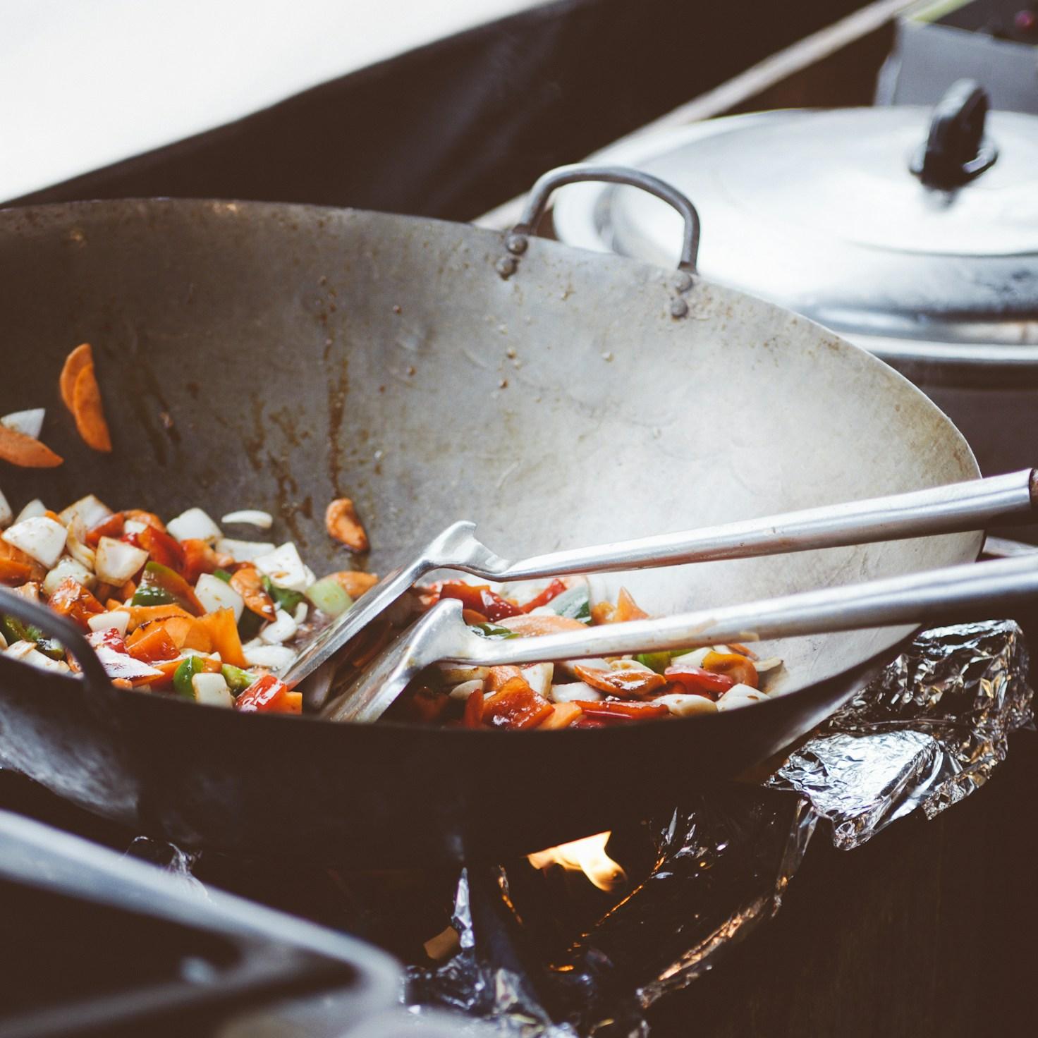 Community members collaborating in a modern kitchen space, sharing recipes and cooking techniques